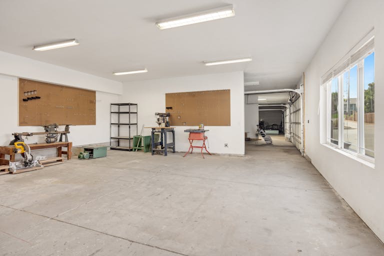 A bright and spacious industrial workshop with machinery and tools.